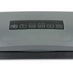 Strip vacuum packaging machine with roll feeder